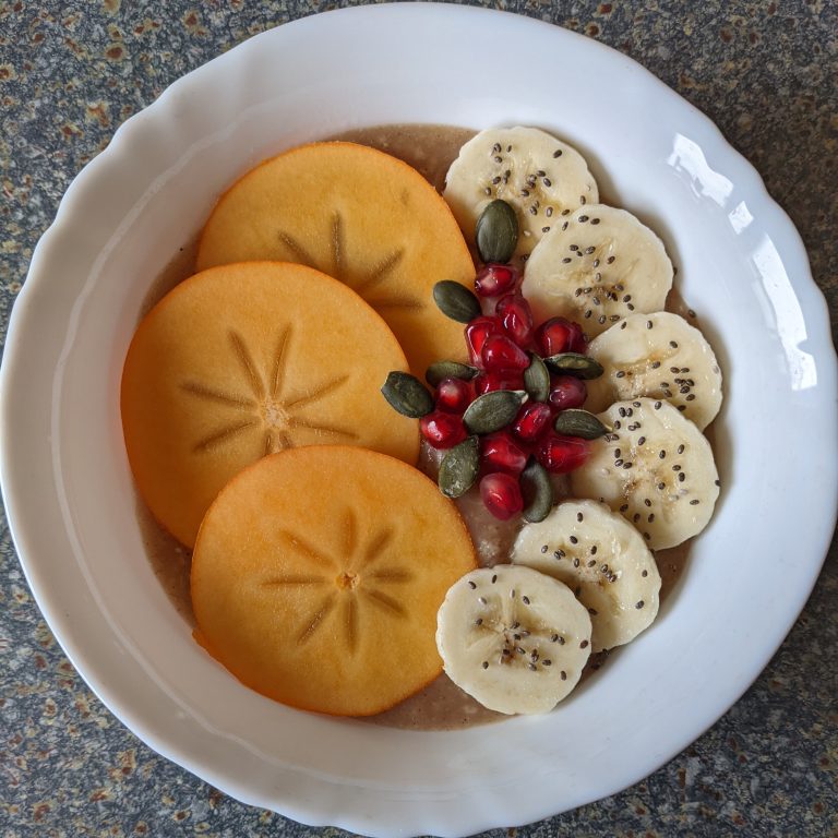 Cinnamon Cooked Oats with Persimmon Banana Pomegranate Pumpkin Seeds & Chia Seeds